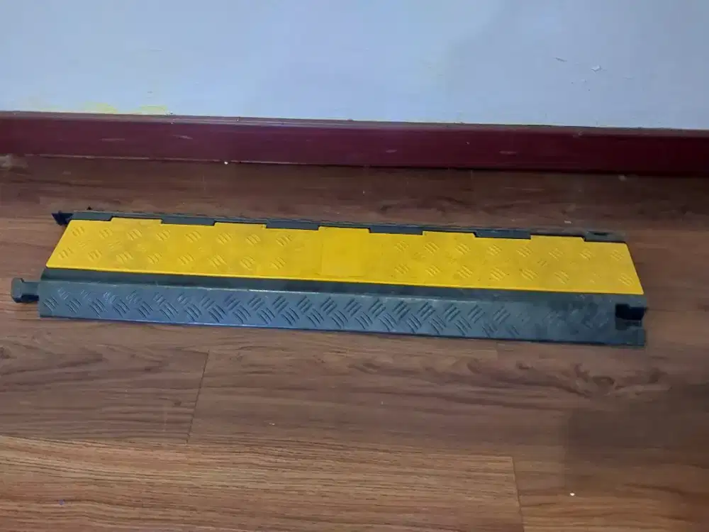 Speed bump cable protector