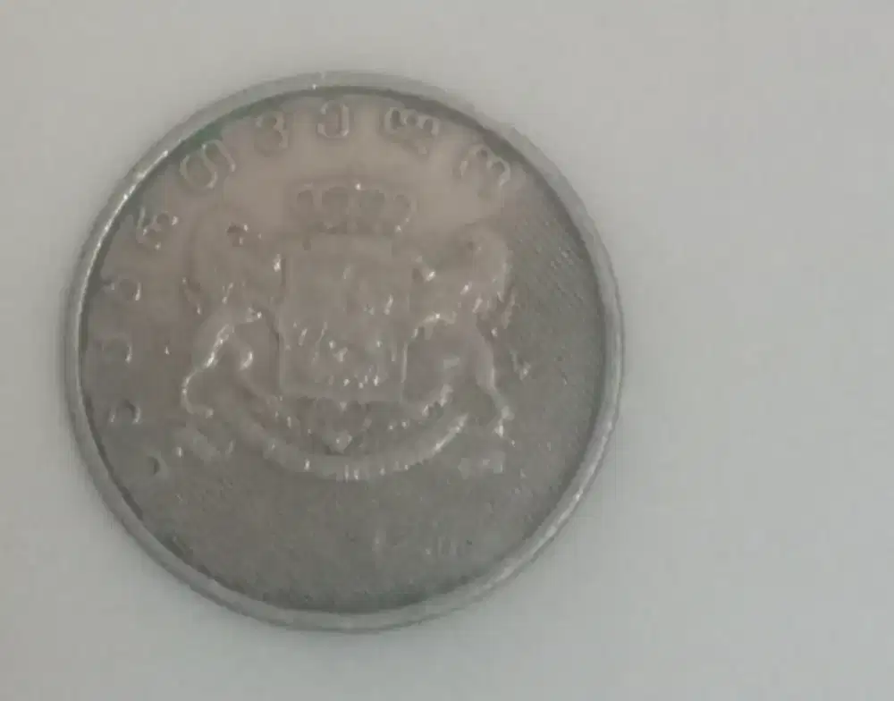 uang koin motif perisai