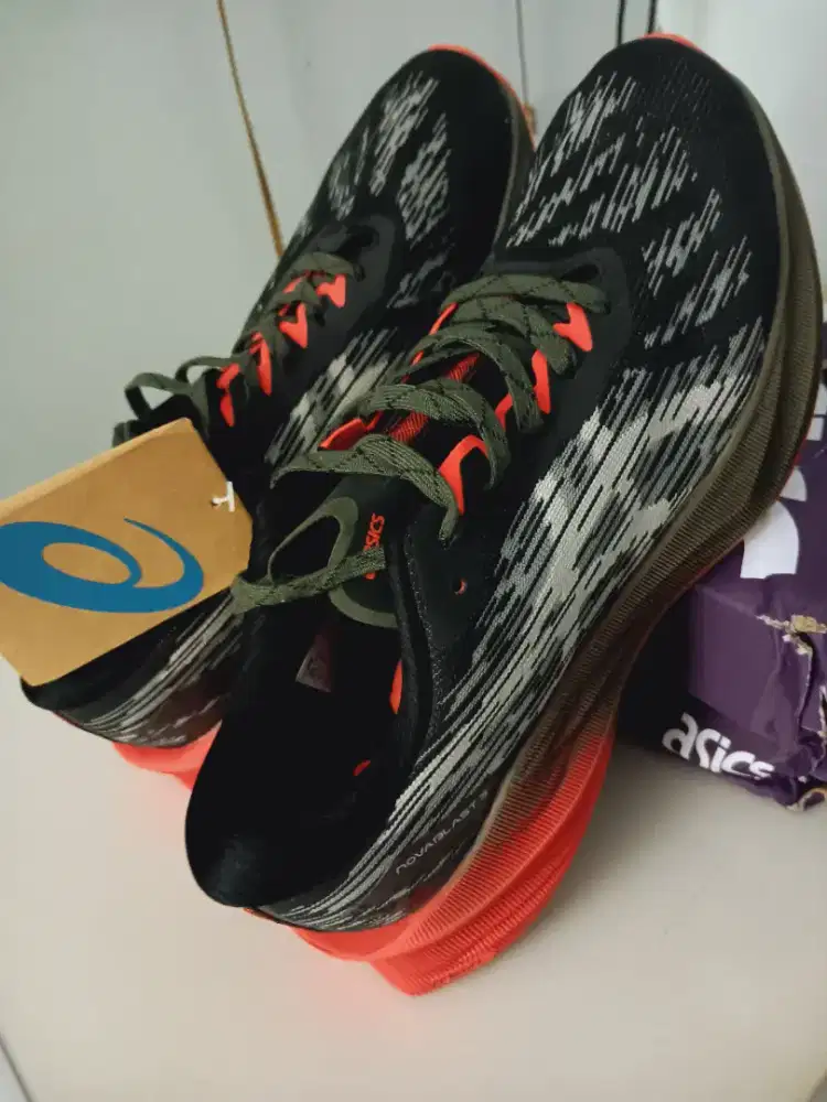 Asics Novablast 3 TR running shoes in an olive green black colorway. 