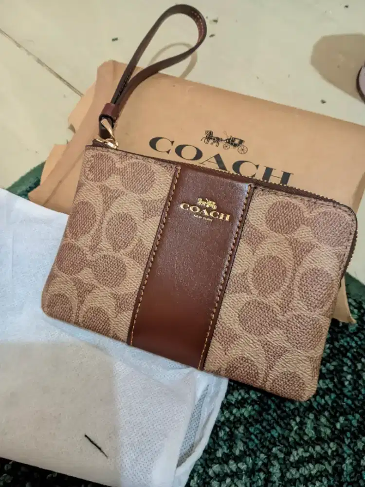 Coach Corner Zip Wristlet in Signature Canvas with Leather Stripe.