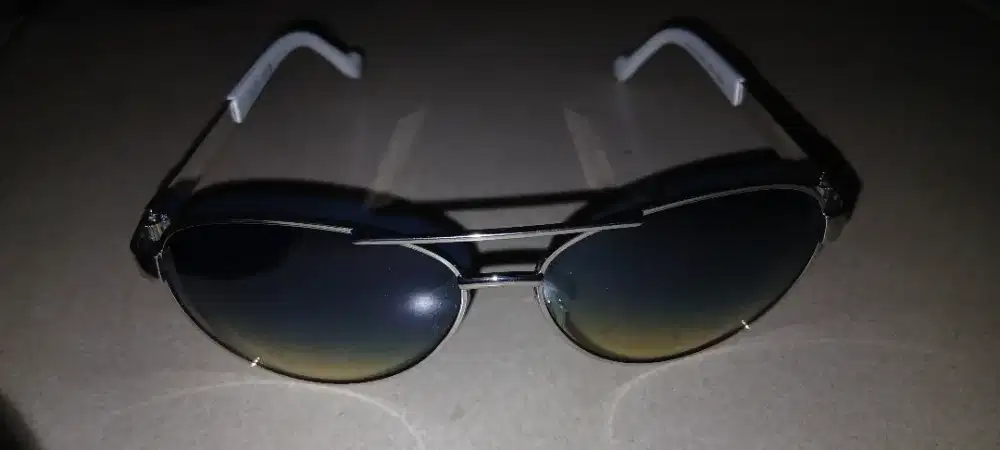 kacamata hitam aviator dengan bingkai logam berwarna perak dan lensa