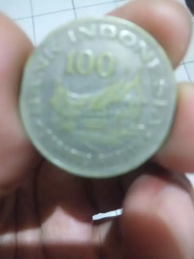 Uang koin kuno bergambar rumah gadang