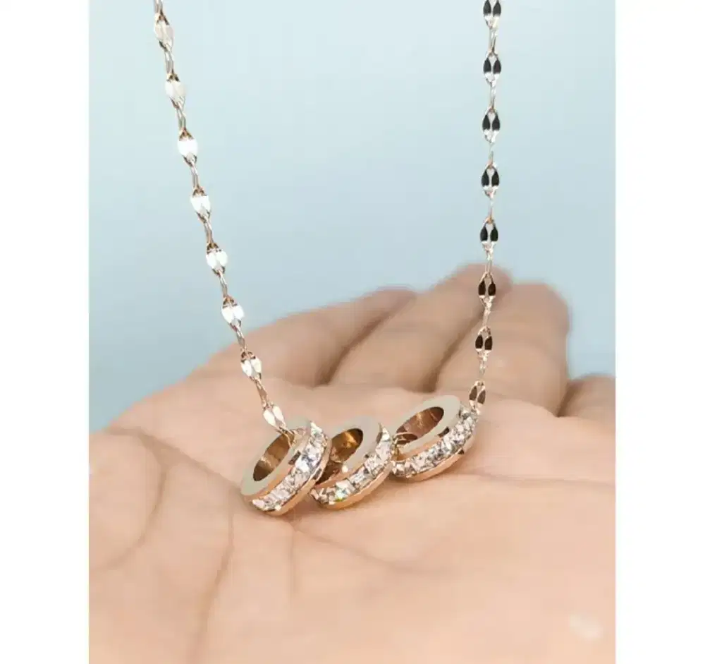 Kalung triple ring pecah kopi gold titanium.