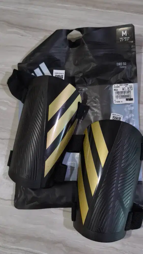 Adidas Tiro Training shin guards in black and gold