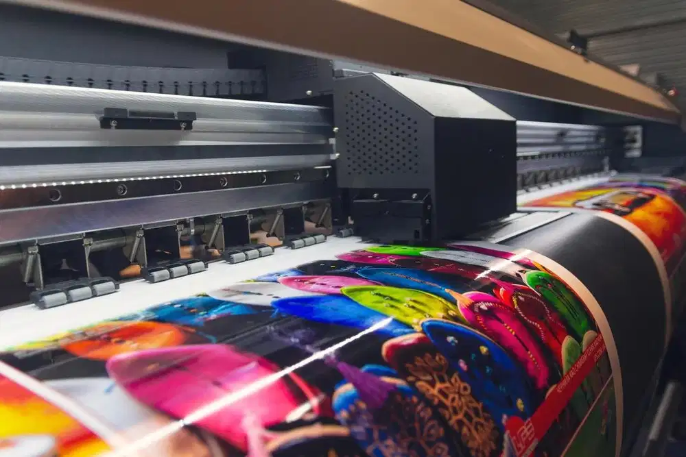 Operator mesin spanduk dan tenaga desain serta tukang fotocopy