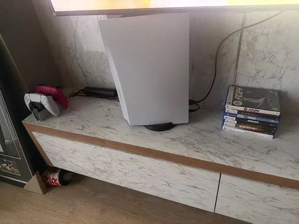 PS5 with game and two controllers