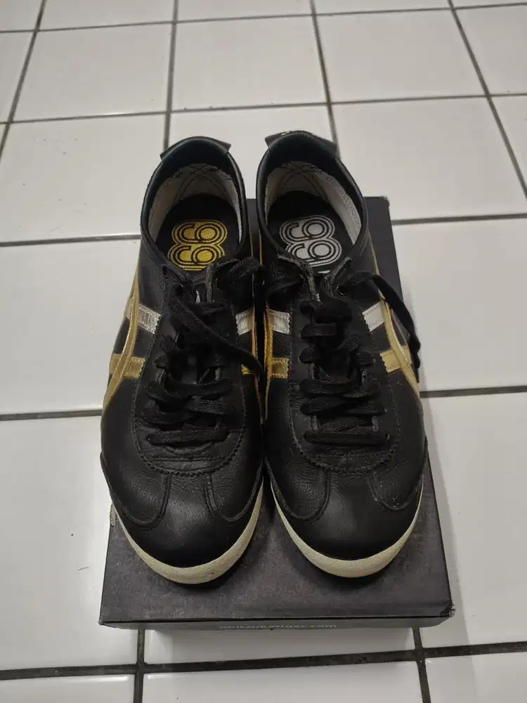 Onitsuka Tiger Mexico 66 sneakers in a black, gold, and silver