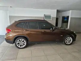 BMW x1 Sdrive 1.8i matic coklat 2012 kilometer 40.000. asli plat L