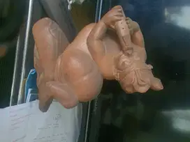 Patung laki-laki Bali sedang meniup seruling
