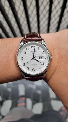 Longines. A stainless steel  White Dial automatic calendar wristwatch