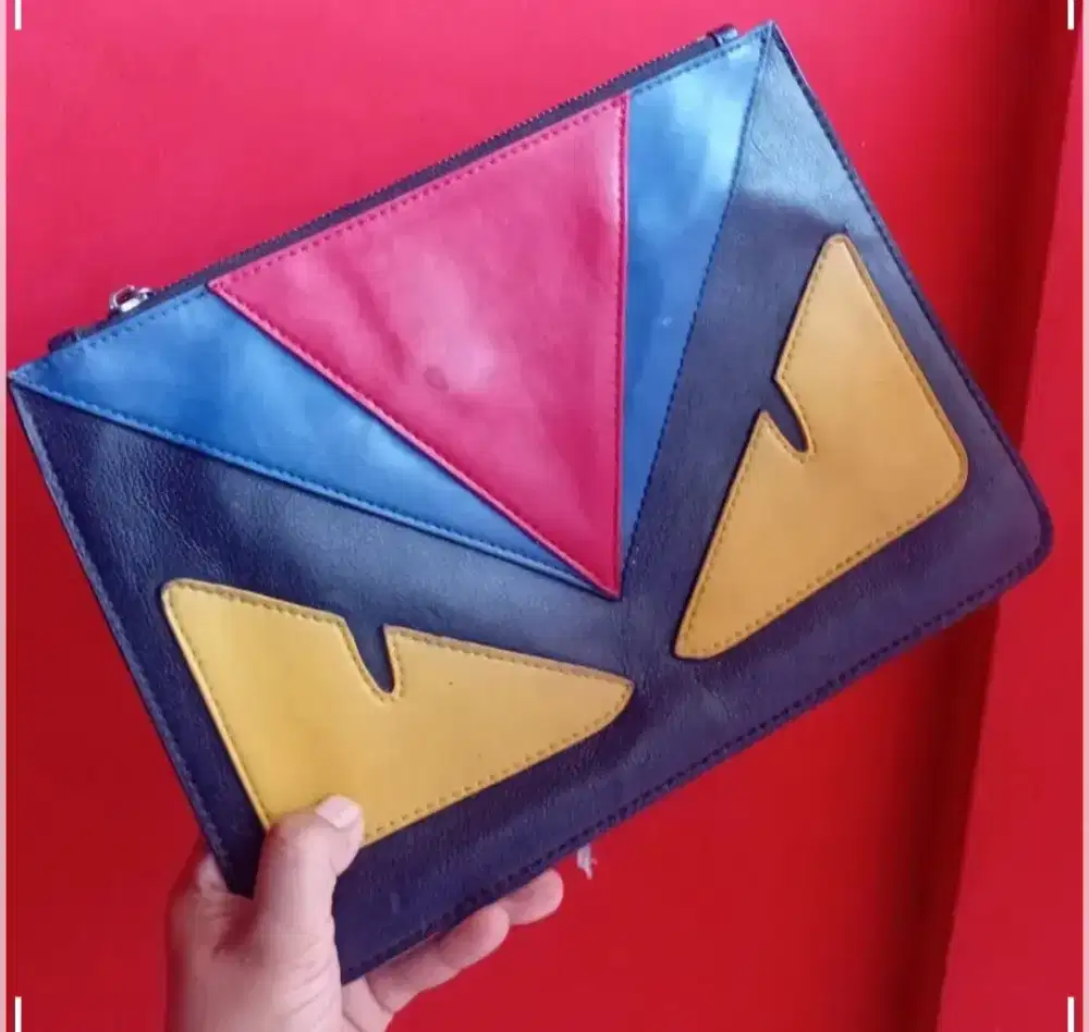 Monster yellow eye clutch bag