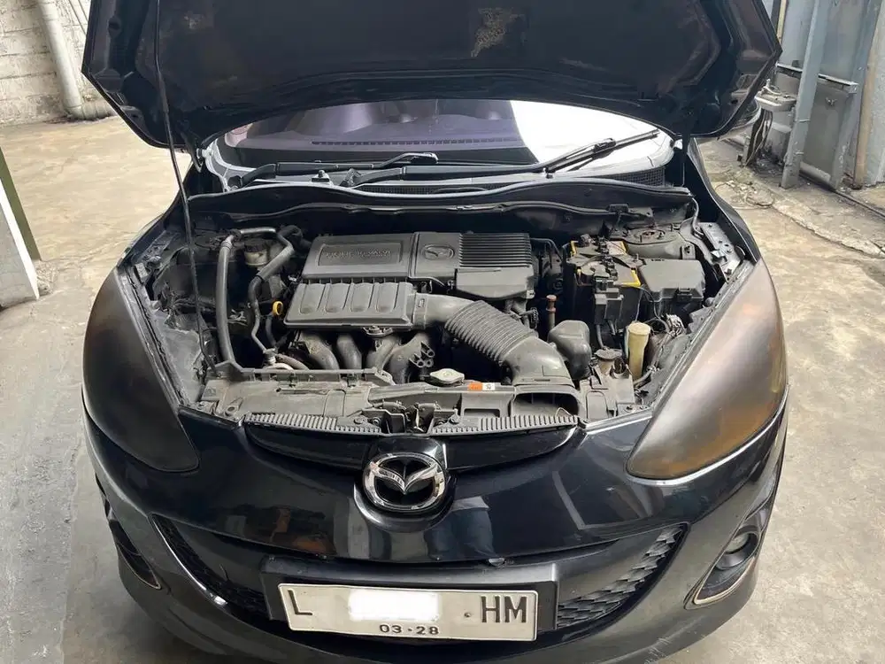 Mazda 2 hitam AT, plat L dari baru, NIK 2012