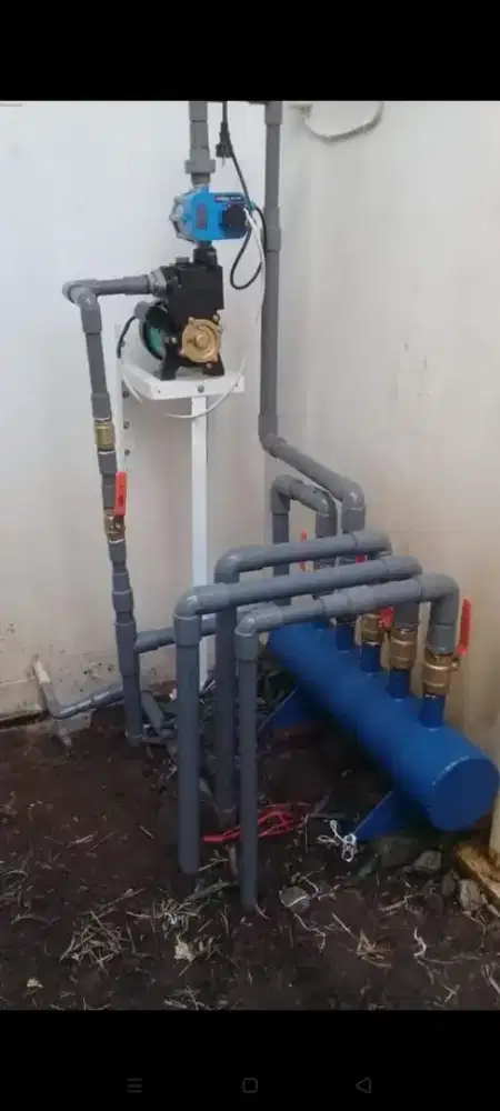 Pemasangan pompa air dan instalasi pipa air