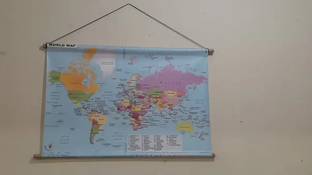 The world map has wood and a hanging rope